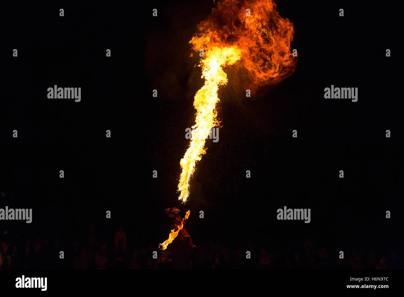 PRAGUE, CZECH REP - OCTOBER 15, 2016: Man fire-eater blowing a large flame from his mouth ( man spits fire) Stock Photo