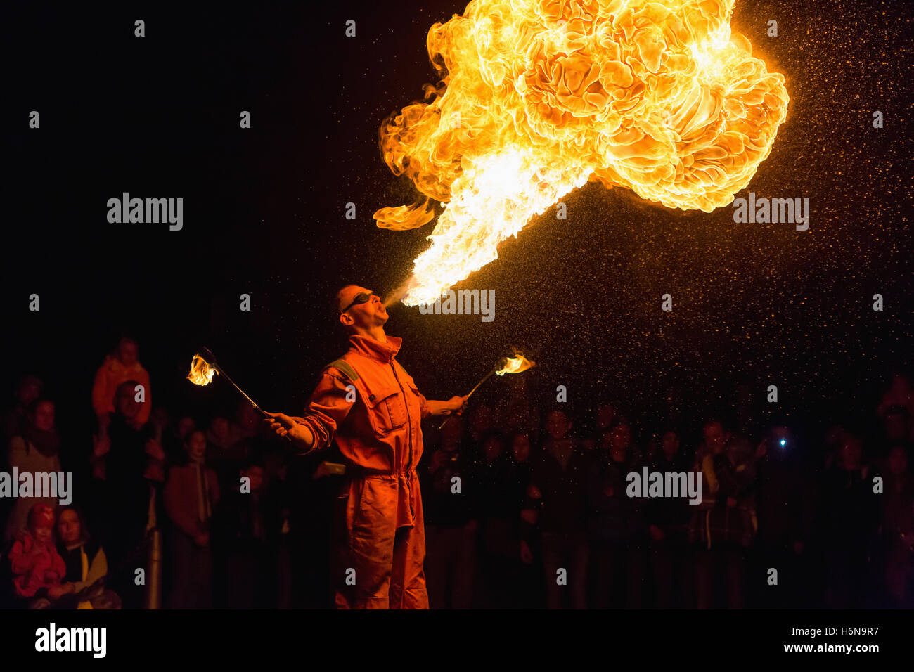 PRAGUE, CZECH REP - OCTOBER 15, 2016: Man fire-eater blowing a large flame from his mouth ( man spits fire) Stock Photo