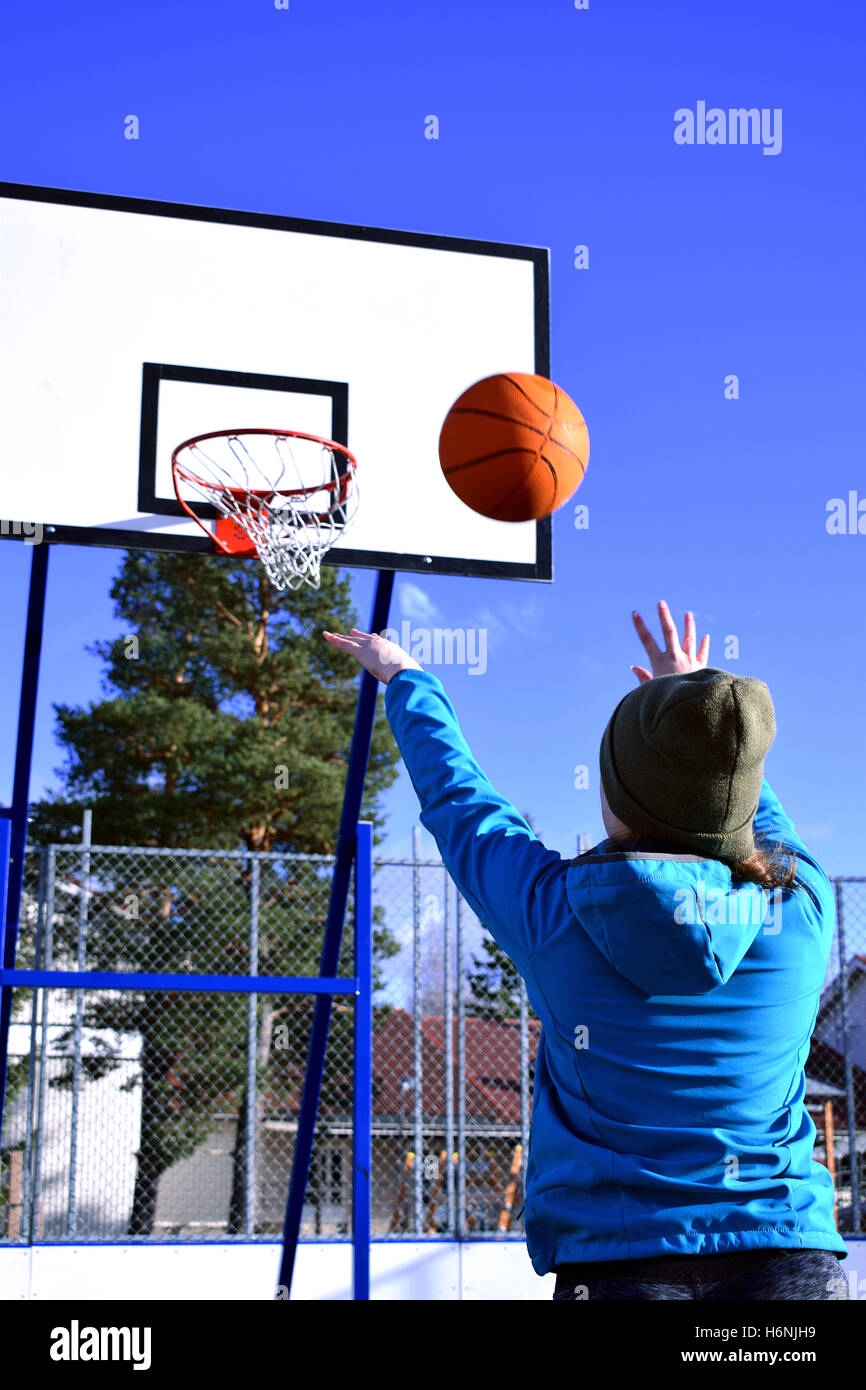 Teen girl throwing basket ball. Stock Photo