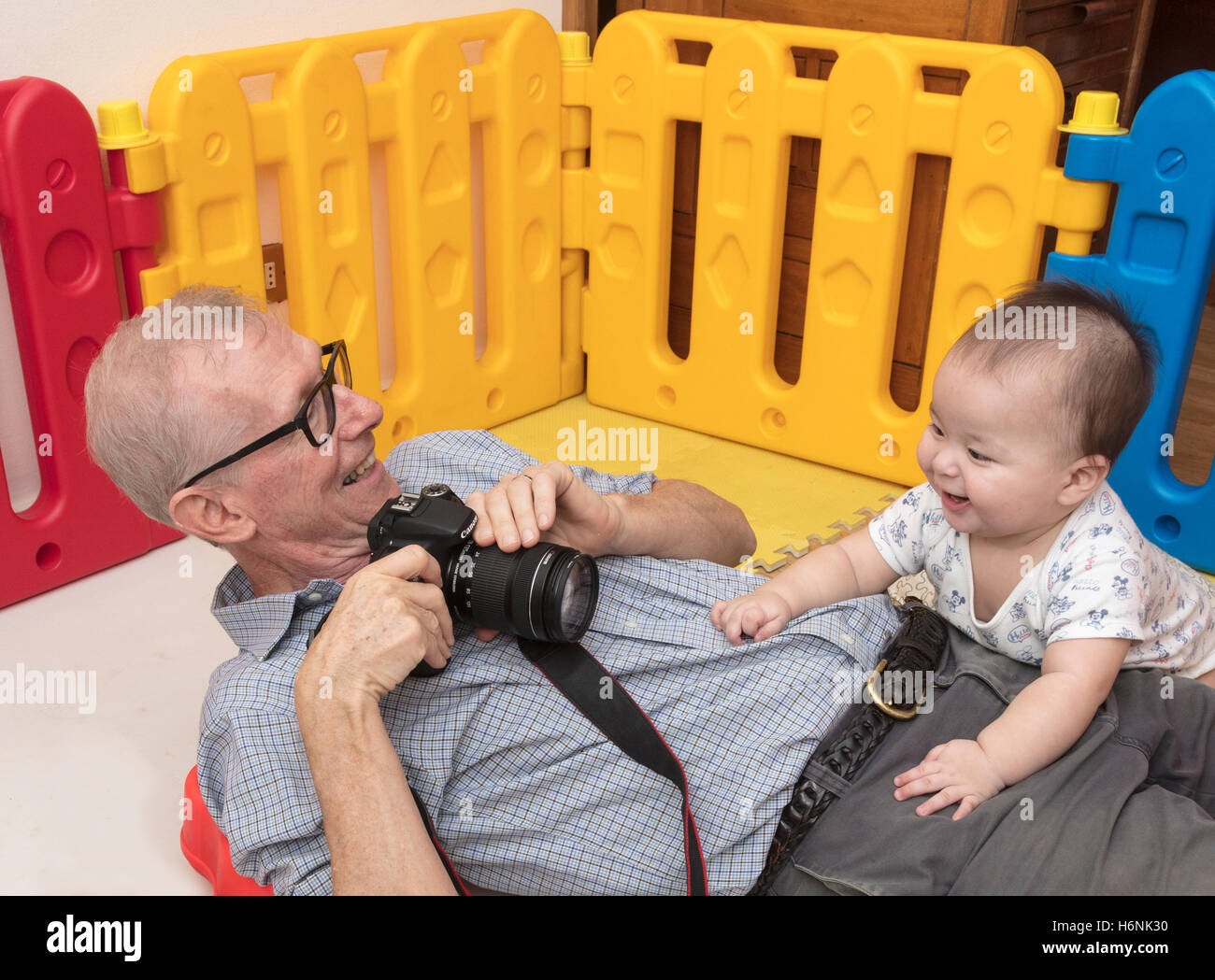 grandfather trying to photograph baby Stock Photo