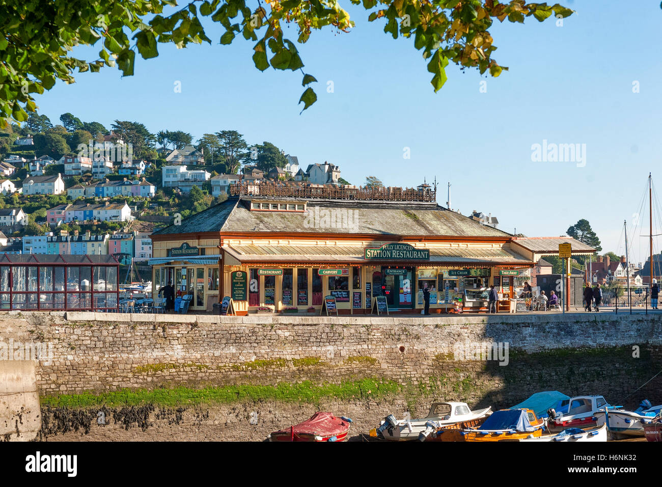 The Station Restaurant Dartmouth, Devon UK from the Boat Float against a clear blue sky with Kingswear in the background Stock Photo
