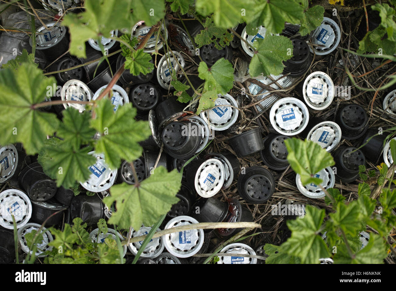 Discarded coffee capsules made of plastic and aluminium amongst the