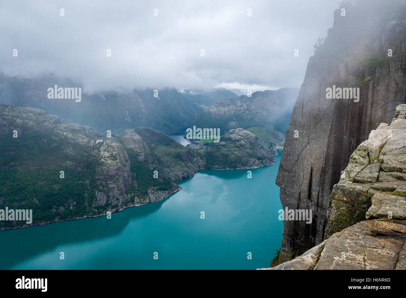 Dangerous high cliff from Prekestolen rock to fjord waters Stock Photo