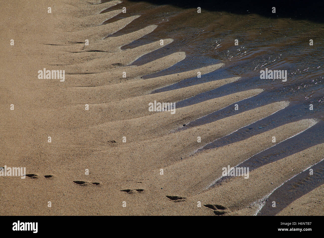 Sand waves on the beach in Lisbon, Portugal Stock Photo