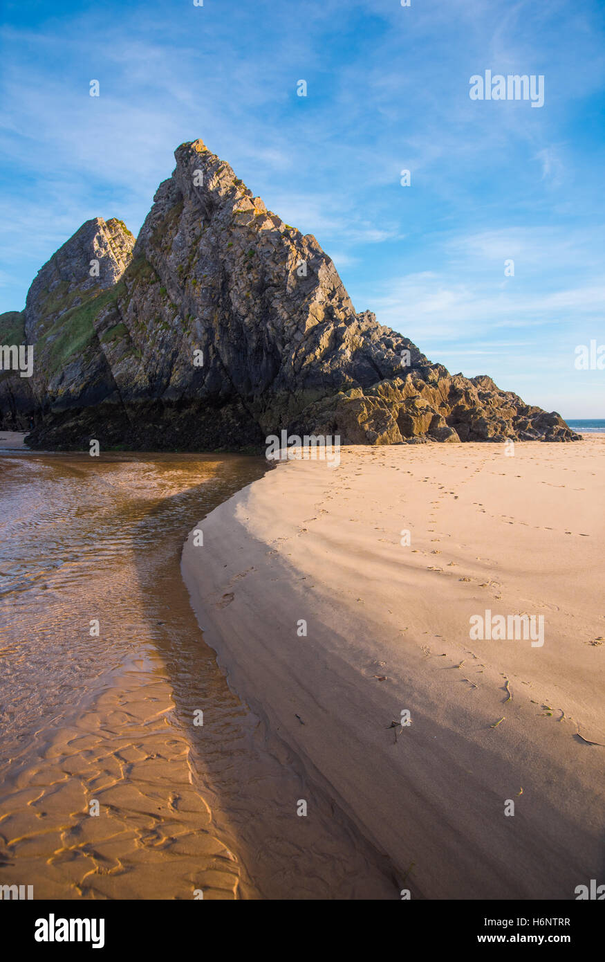 Pennard Pill flows past the three cliffs at Three Cliffs Bay, Gower, South Wales, UK. Stock Photo