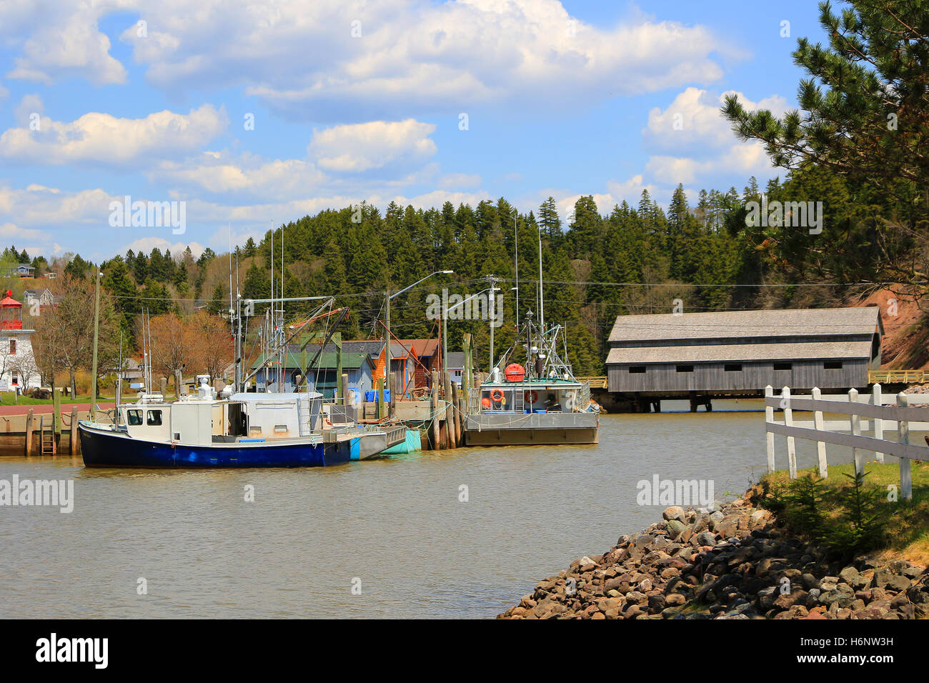 Boat and covered Bridge in St. Martins, New Brunswick during High Tide