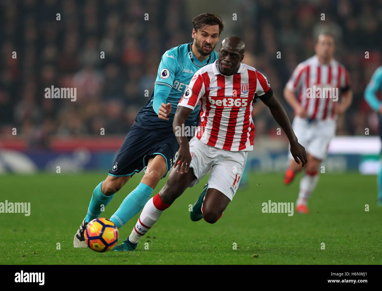Swansea City's Fernando Llorente and Stoke City's Bruno Martins Indi battle for the ball during the Premier League match at the Bet365 Stadium, Stoke. Stock Photo