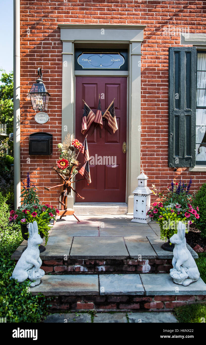 Vintage red colour house front door porch with US flags, rabbits and