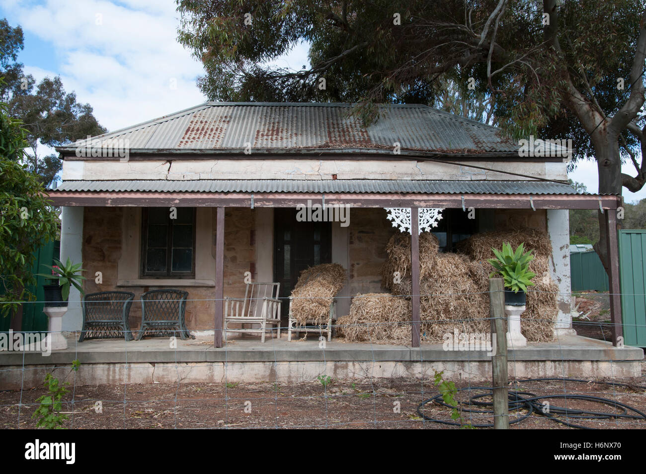 Hay bales stacked on the verandah of an old house on the Seppeltsfield Estate, Barossa Valley, South Australia Stock Photo