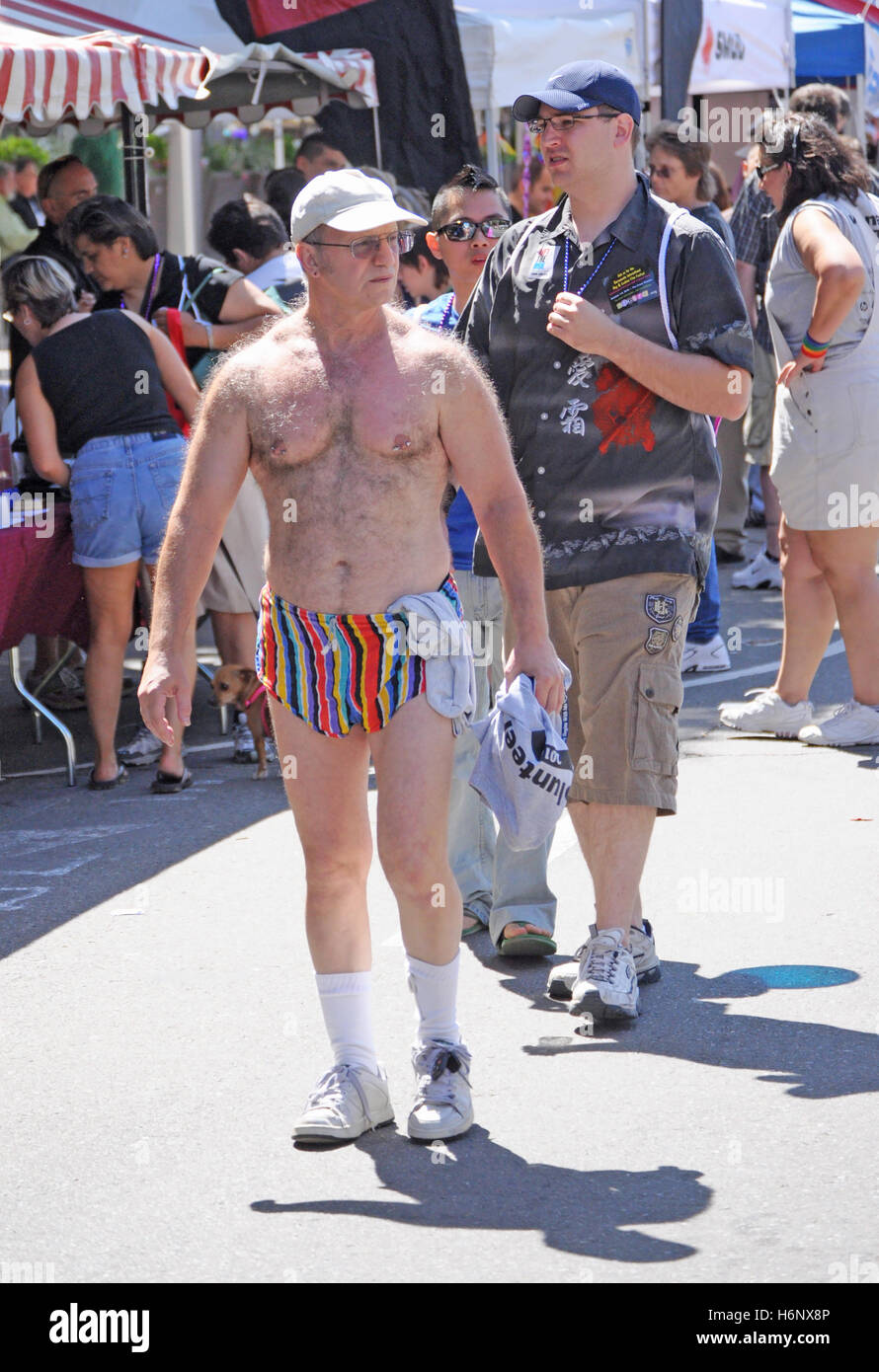 A confident hairy male with nipple piercings in short shorts walks through  Sacramento gay pride with his keys tied to his shoe laces Stock Photo -  Alamy