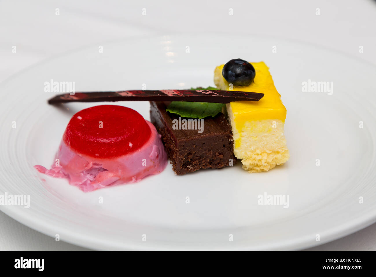 Three desserts on a white plate Stock Photo
