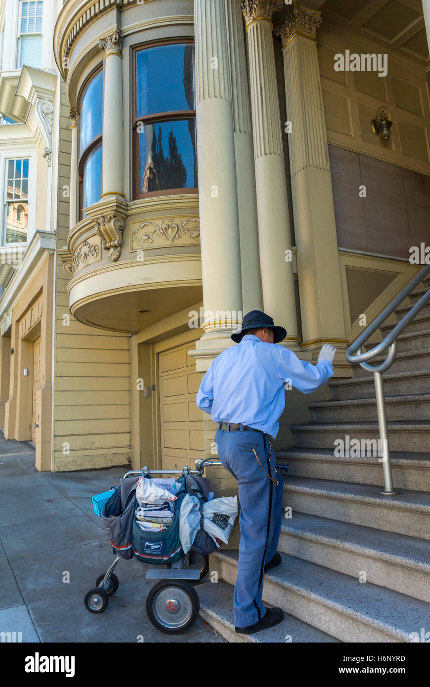San Francisco, CA, USA, Mailman CLimbing Stairs to Deliver Mail at Victorian Townhouses in FIllmore District, people stairs walking Stock Photo