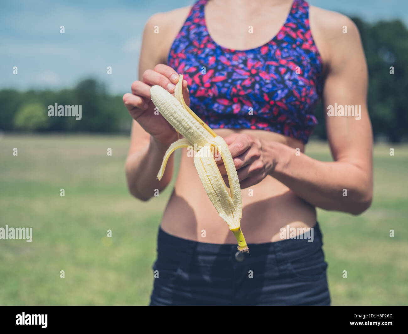 Young woman peeling banana in hi-res stock photography and images - Alamy