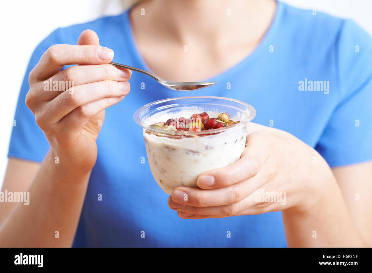 Close Up Of Woman Eating Healthy Dessert Of Yogurt With Nuts And Seeds