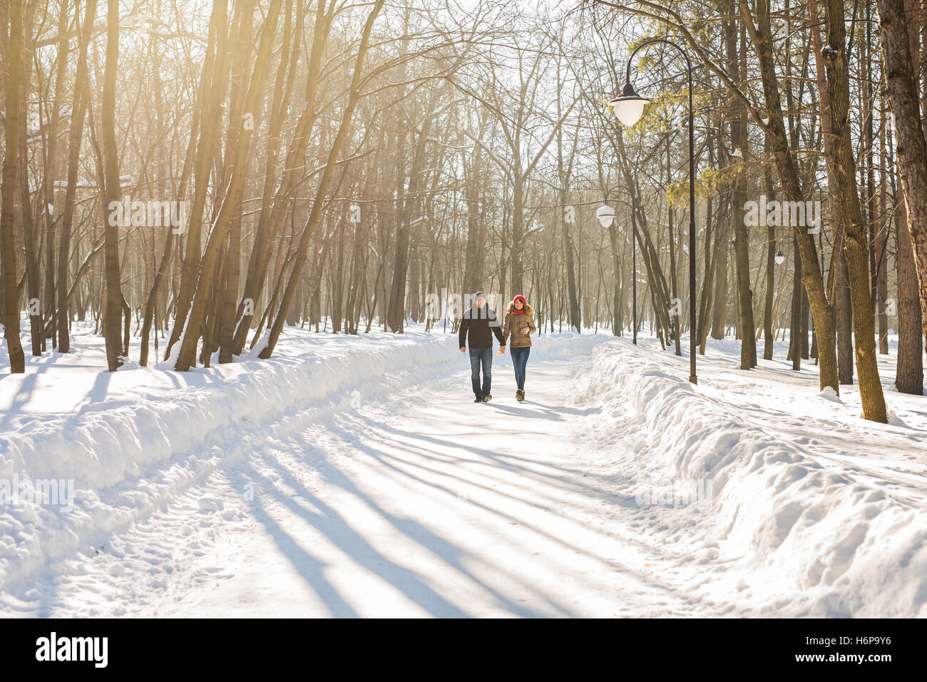 happy couple walking through a snowy forest in winter Stock Photo - Alamy