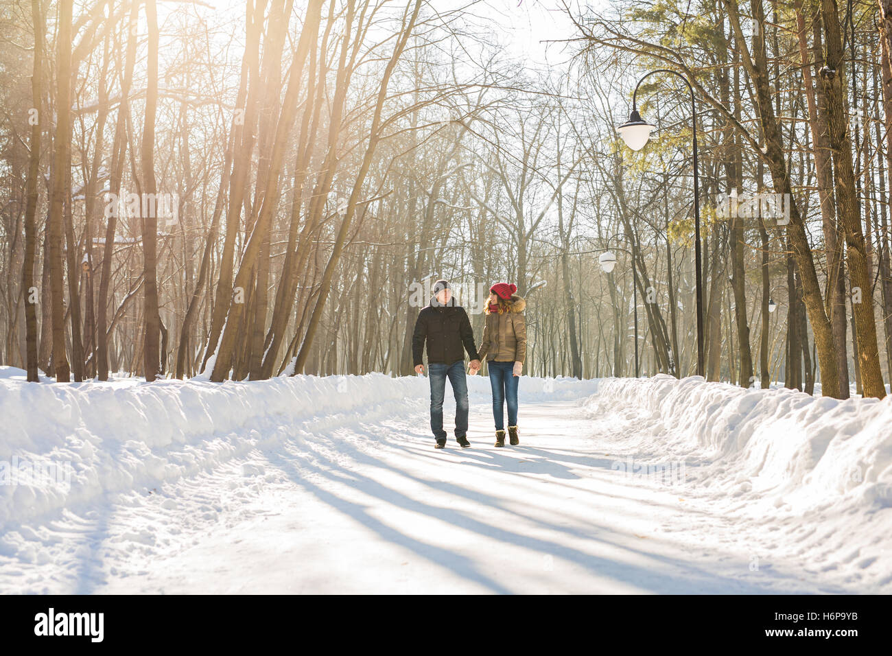 happy couple walking through a snowy forest in winter Stock Photo - Alamy