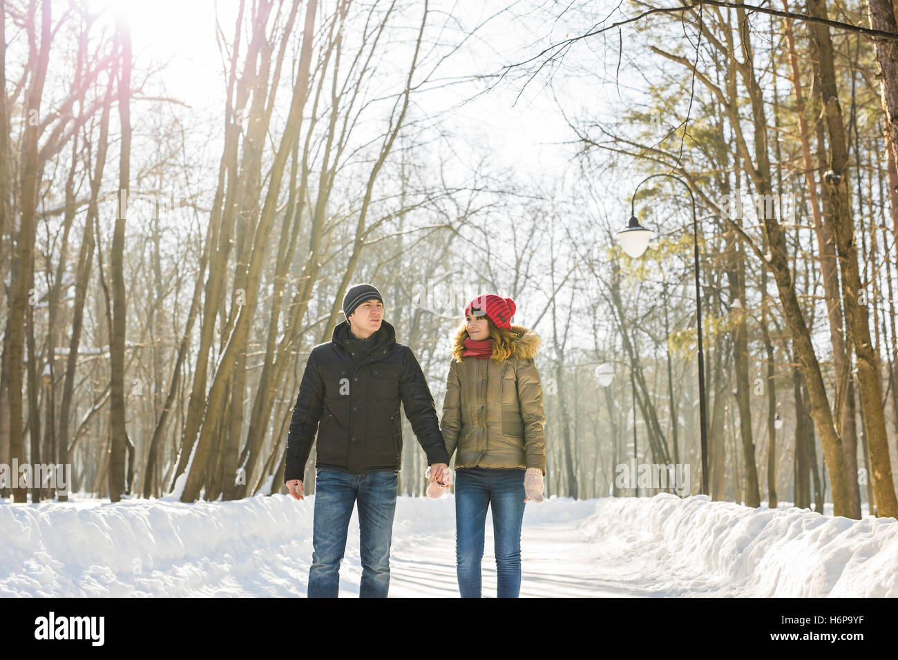 happy couple walking through a snowy forest in winter Stock Photo - Alamy