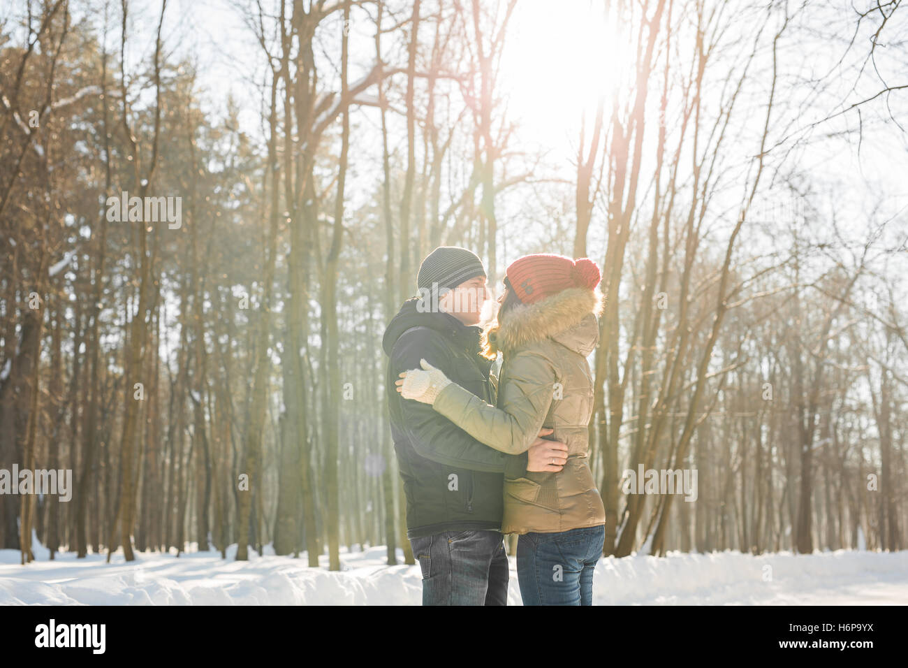 Happy Young Couple in Winter Park having fun. Family Outdoors. love