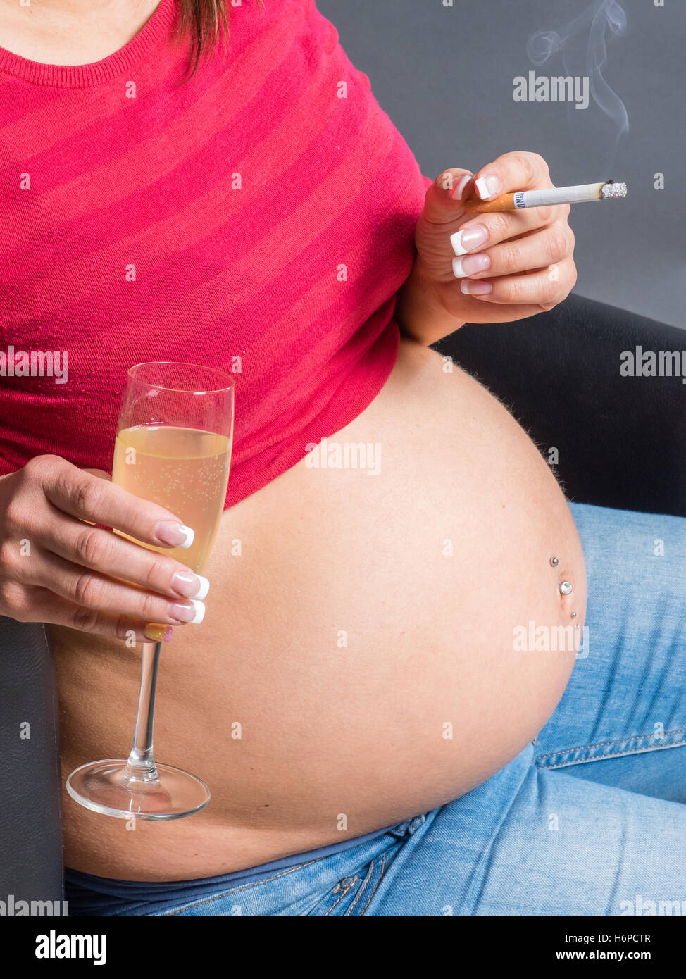 pregnant woman drinking Alcohol an smoking cigarette. Stock Photo