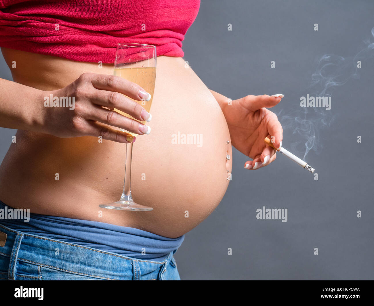 pregnant woman smoking cigarette and drinking Alcohol. unhealthy habits Stock Photo