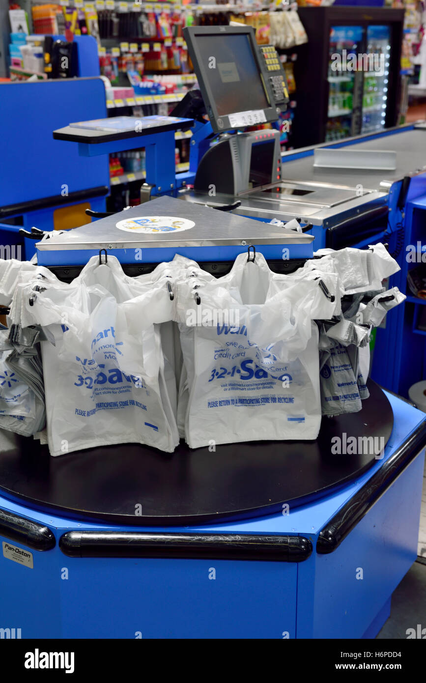 Shopping bag carousel inside Walmart store to allow faster customer checkout Stock Photo