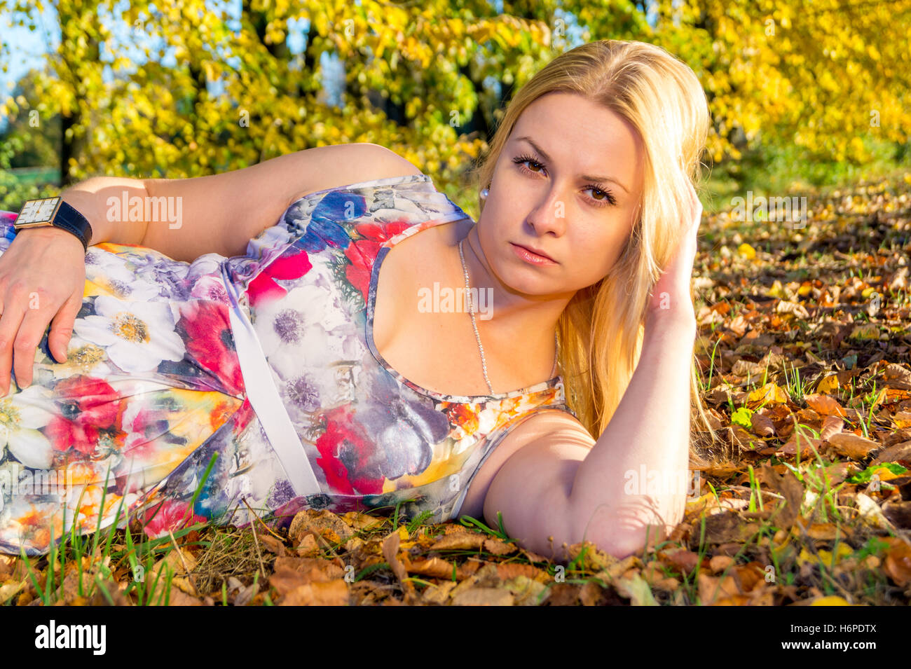 Beautiful woman in autumn park with yellow leaves Stock Photo - Alamy