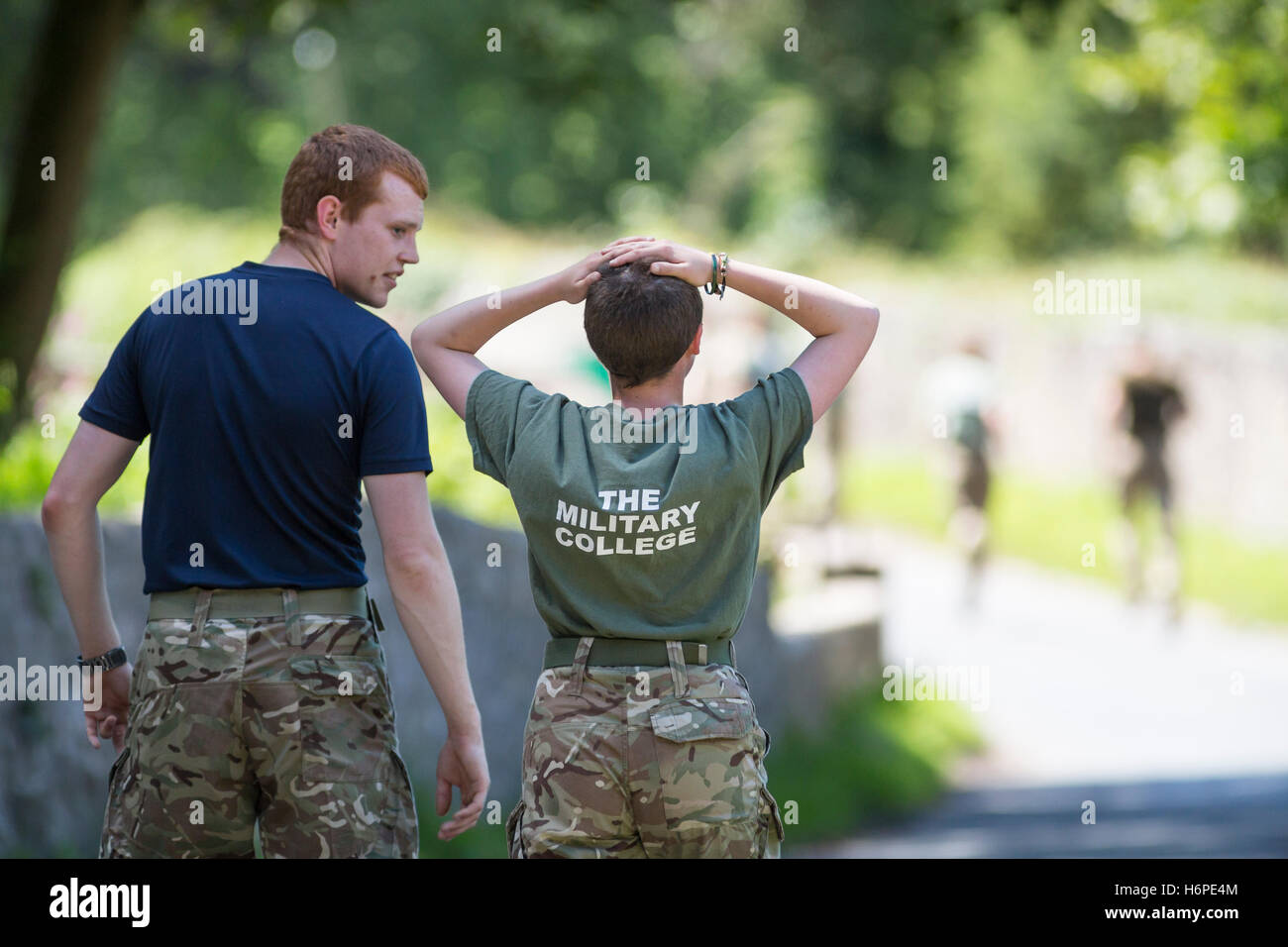 young people showing teamwork and support on military physical training exercise Stock Photo