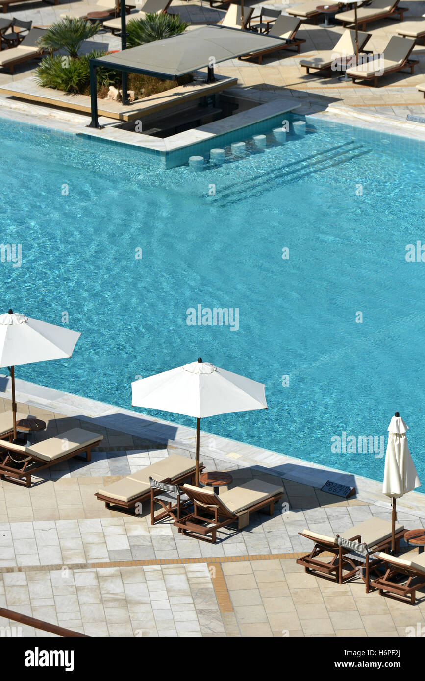 Sun Loungers Umbrellas And Tables Around A Swimming Pool Stock Photo Alamy