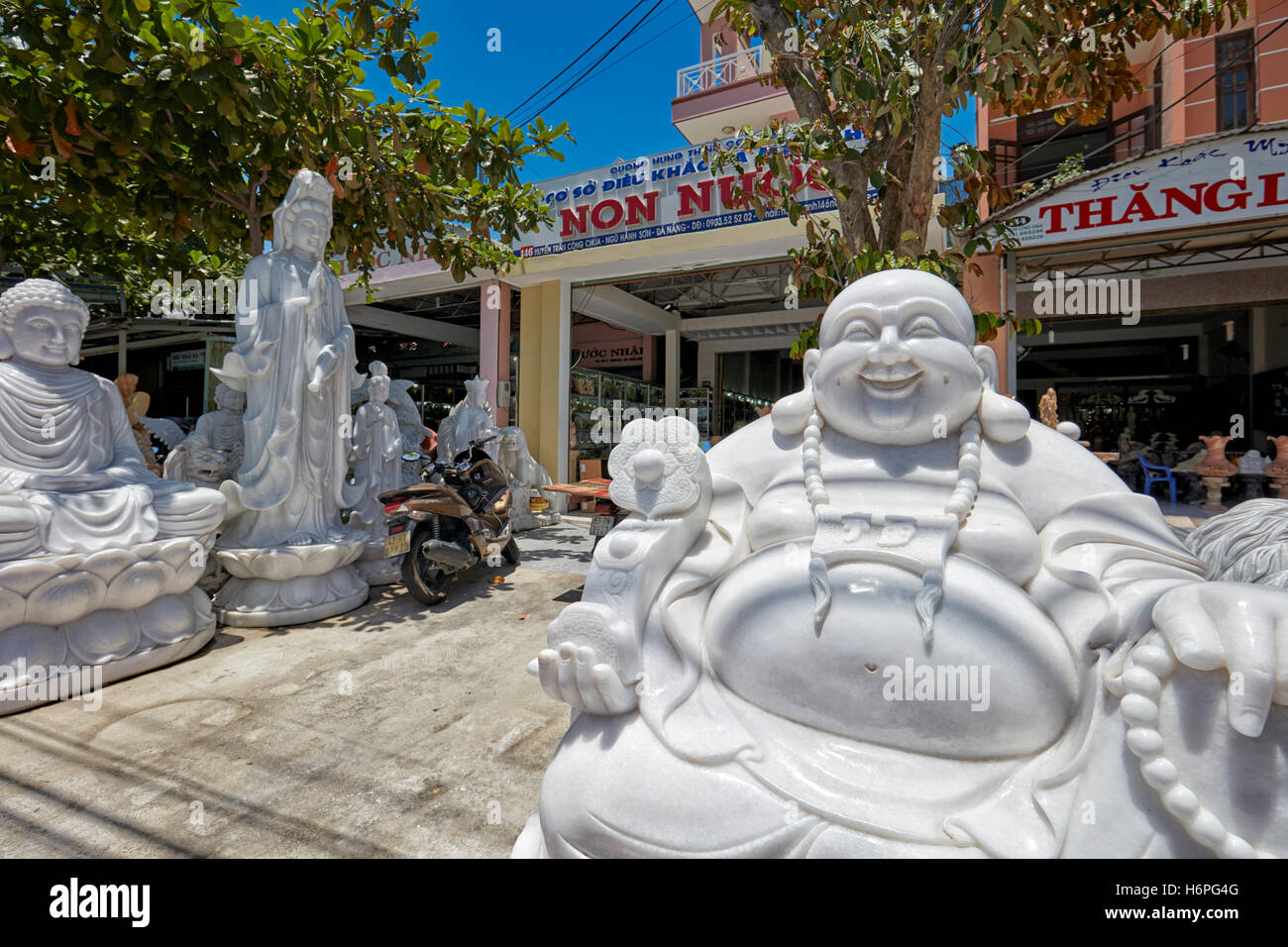 Marble Buddha statues displayed at shopfront. The Marble Mountains, Da Nang, Vietnam. Stock Photo