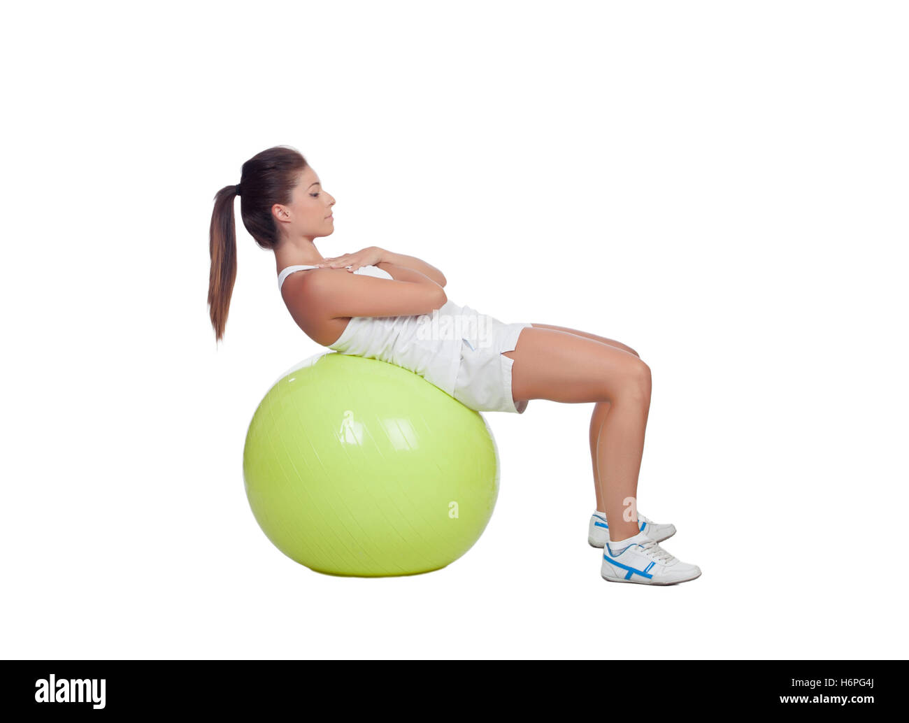 Attractive girl practicing abdominal on a big ball isolated on a white background Stock Photo