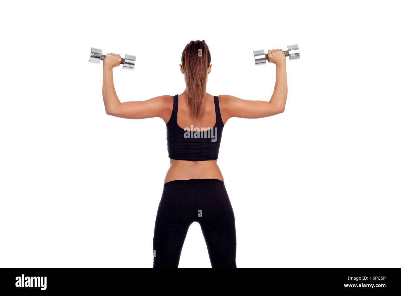 Fitness woman back lifting dumbbells isolated on white background Stock Photo