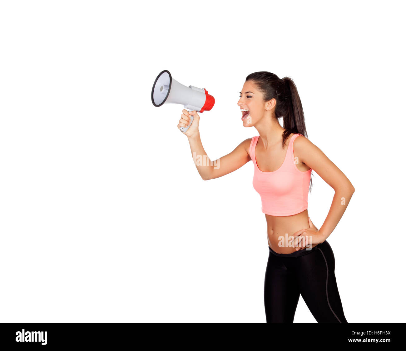 Attractive girl with fitness clothing and megaphone isolated on a white background Stock Photo