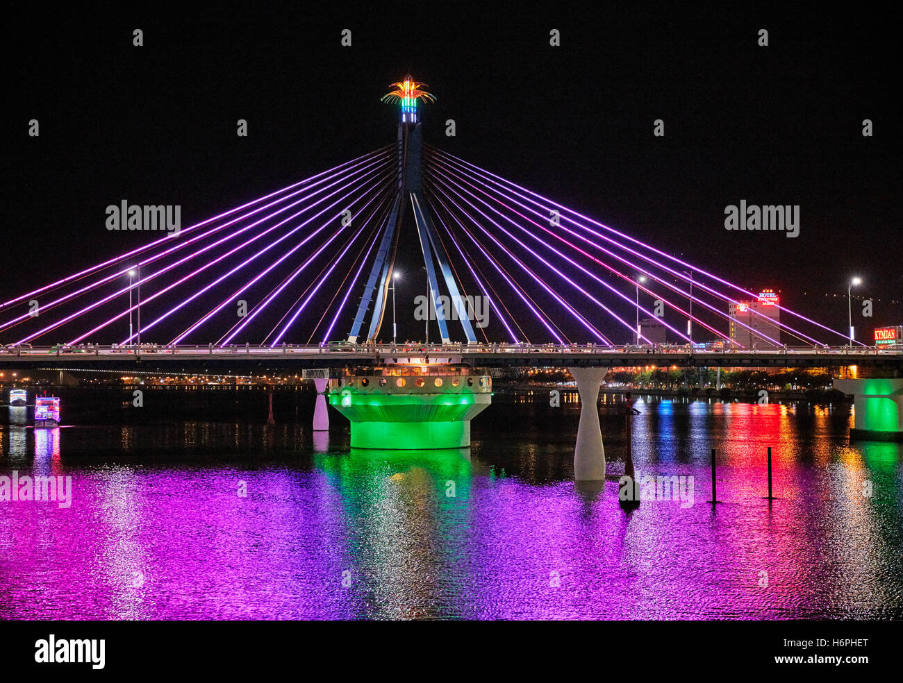 Han River Bridge (Cau Song Han) colorfully illuminated at night. Da Nang city, Vietnam. Stock Photo