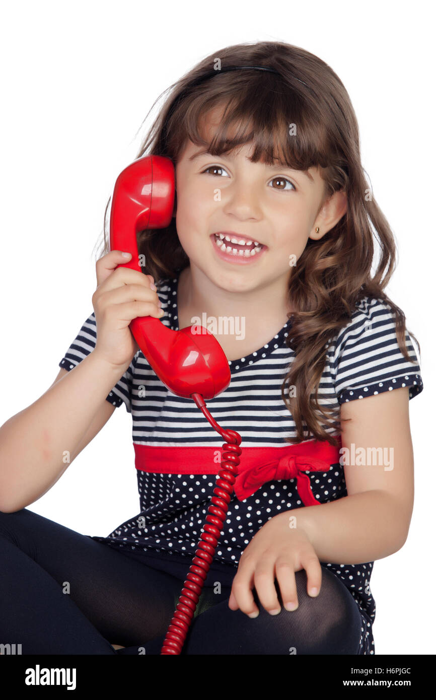 Adorable little girl wiht red phone isolated on white background Stock