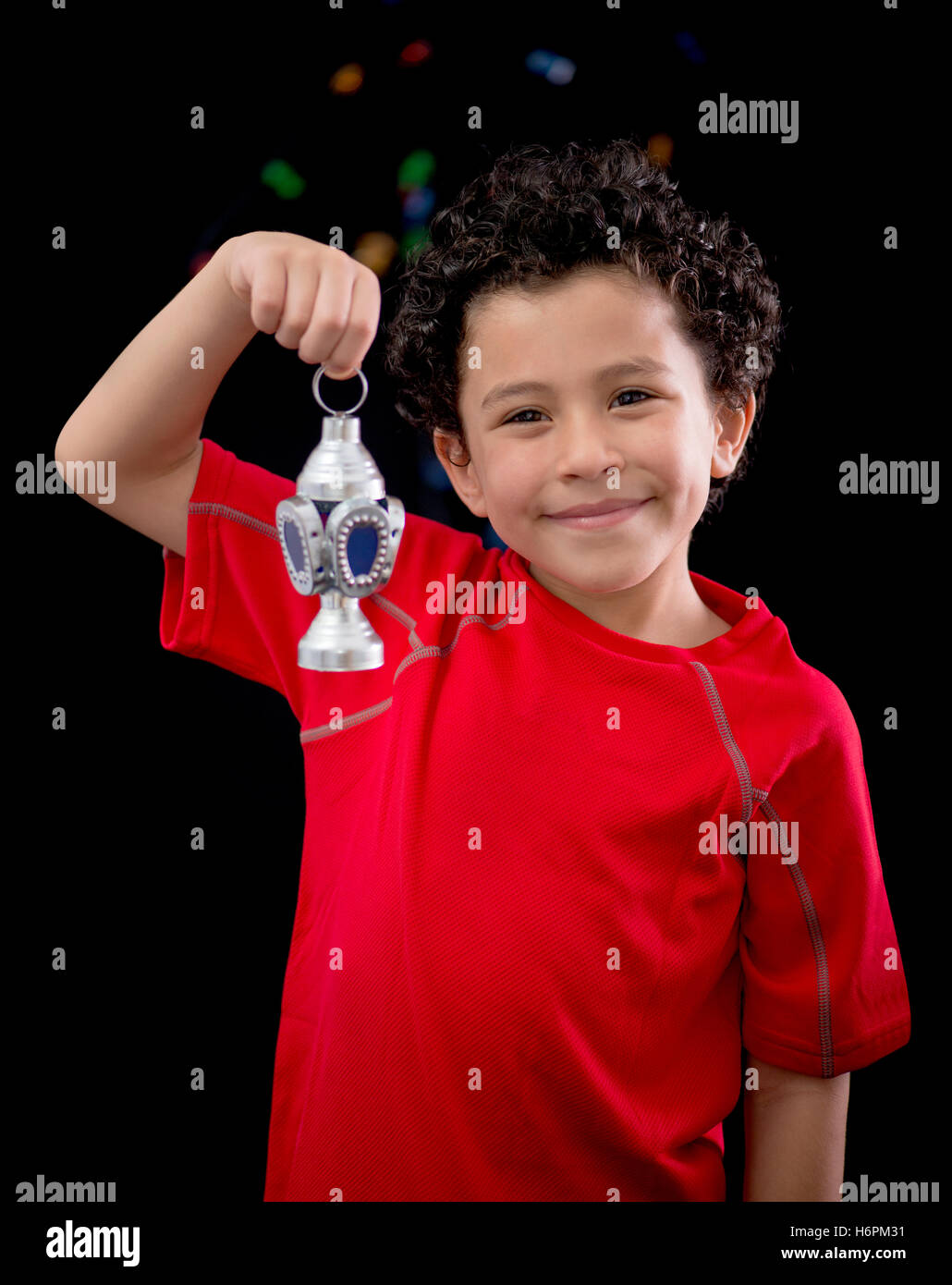 Happy Child with Ramadan Lantern on Defocused Night Lights Background Stock Photo