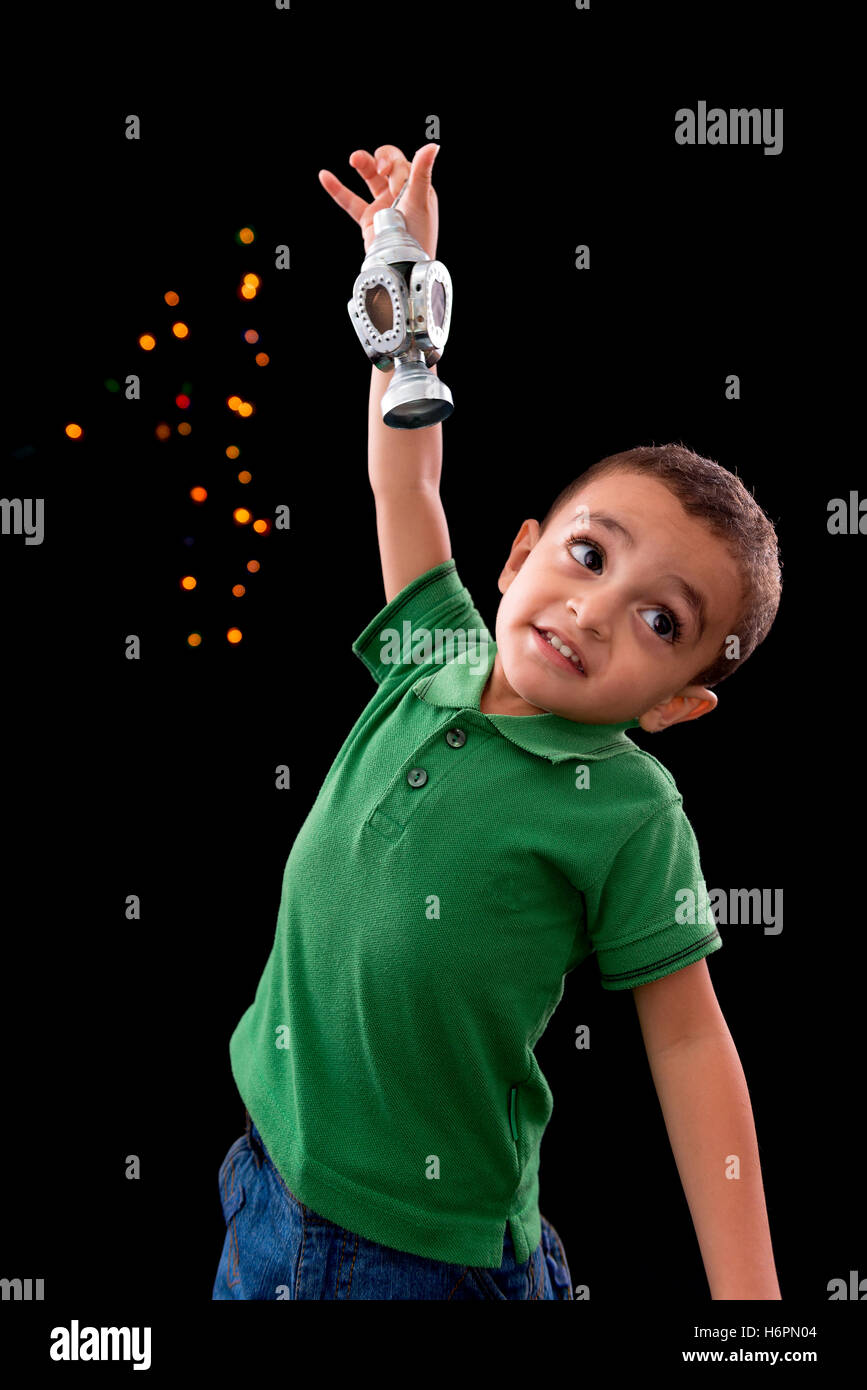 Happy Little Boy with Ramadan Lantern on Defocused Night Lights Background Stock Photo