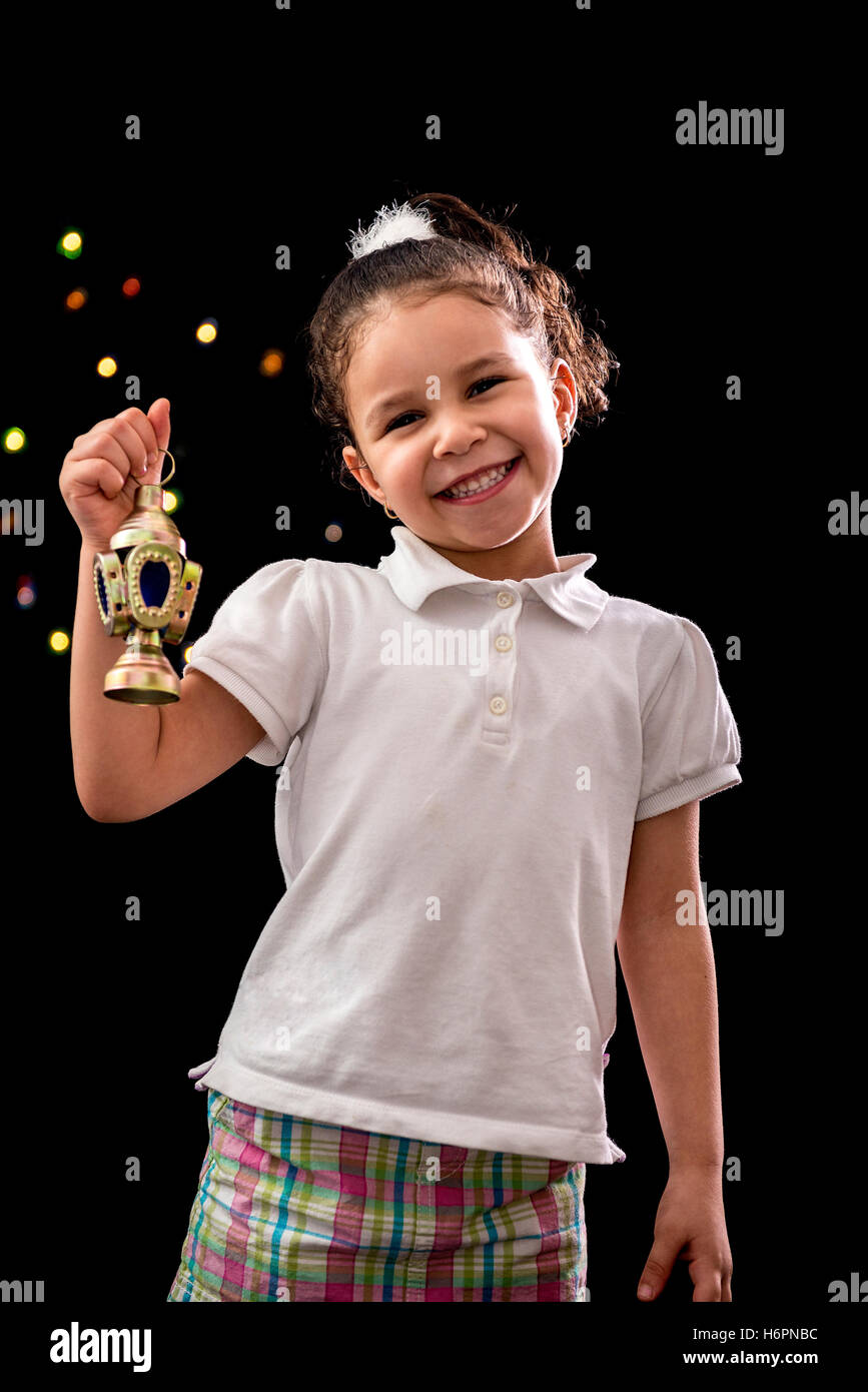 Happy Young Girl with Ramadan Lantern on Defocused Night Lights Background Stock Photo