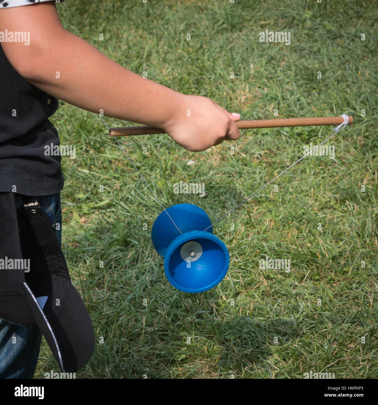 Diabolo Plastic Chinese Toy, Child With Yoyo with Rope and Sticks Stock  Photo - Alamy