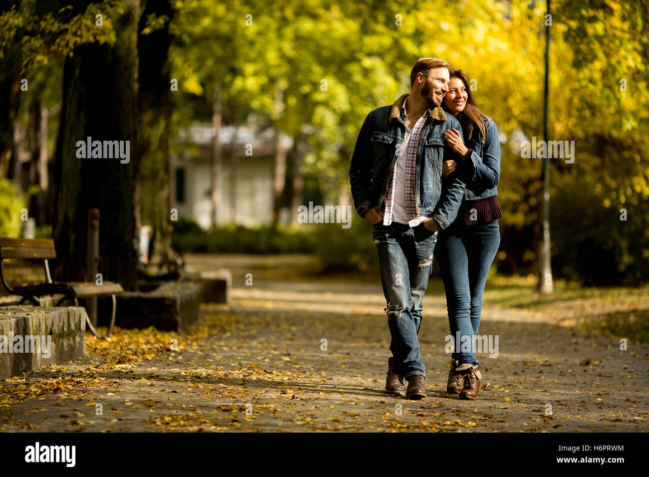Young loving couple having a walk in the autumn park Stock Photo - Alamy