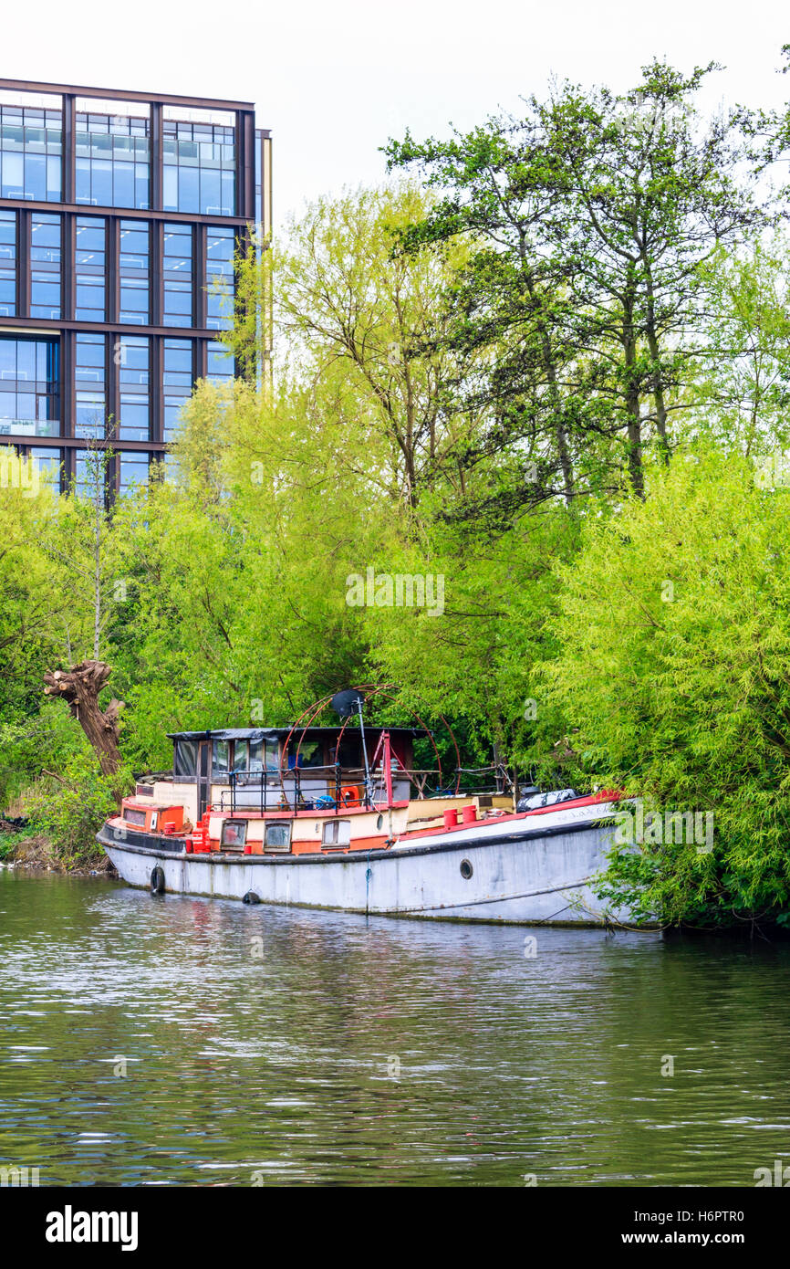 Houseboat moored on Regent's Canal by Camley Street Nature Reserve, London, UK, during the King's Cross redevelopment, 2015 Stock Photo