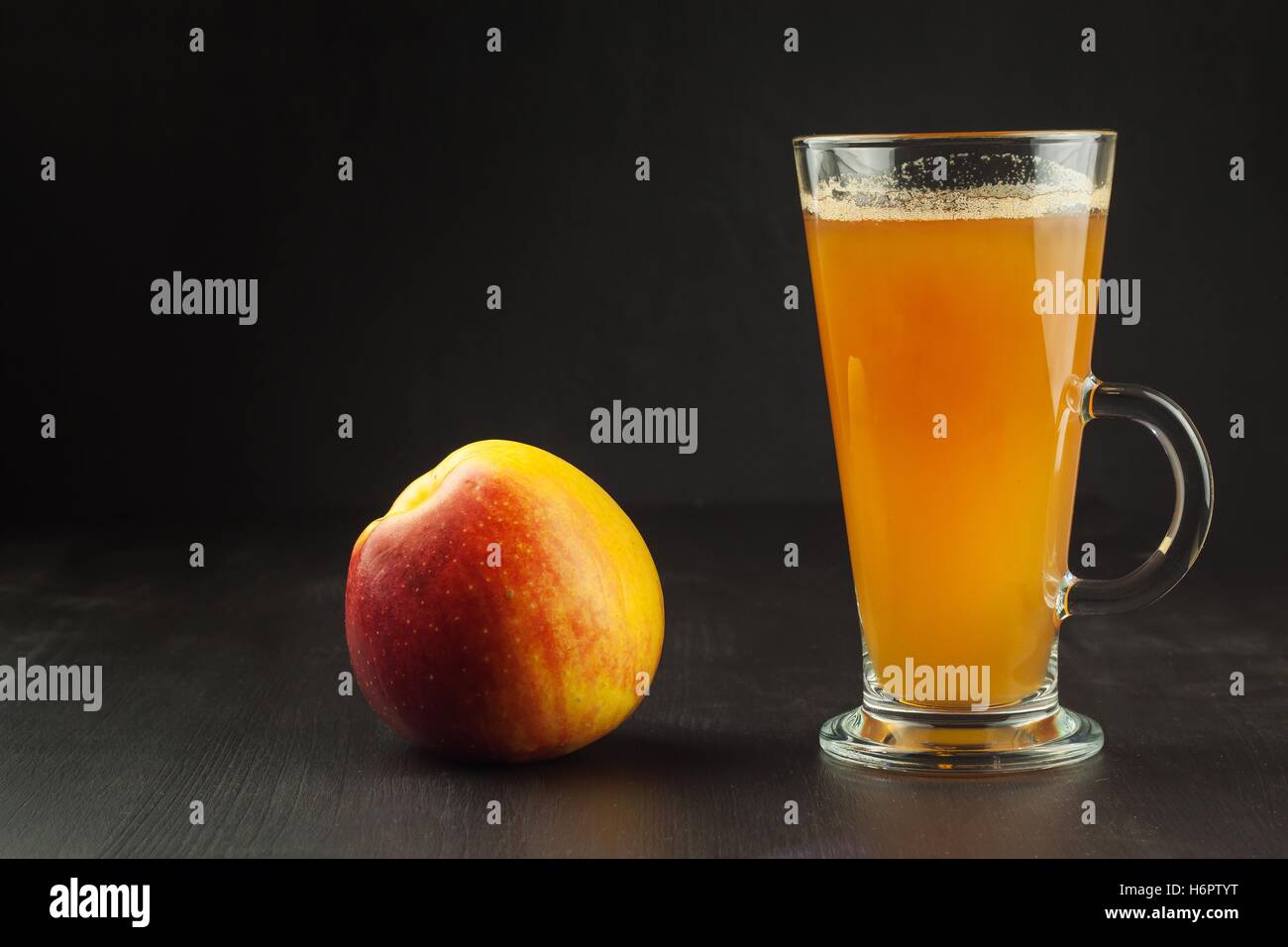 Healthy fresh apple juice drink on wooden background. Domestic