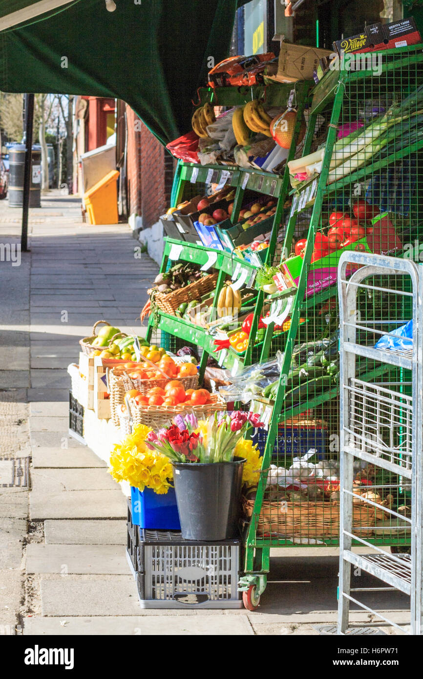 Fruit and veg on display outside a local convenience store in North London, UK Stock Photo