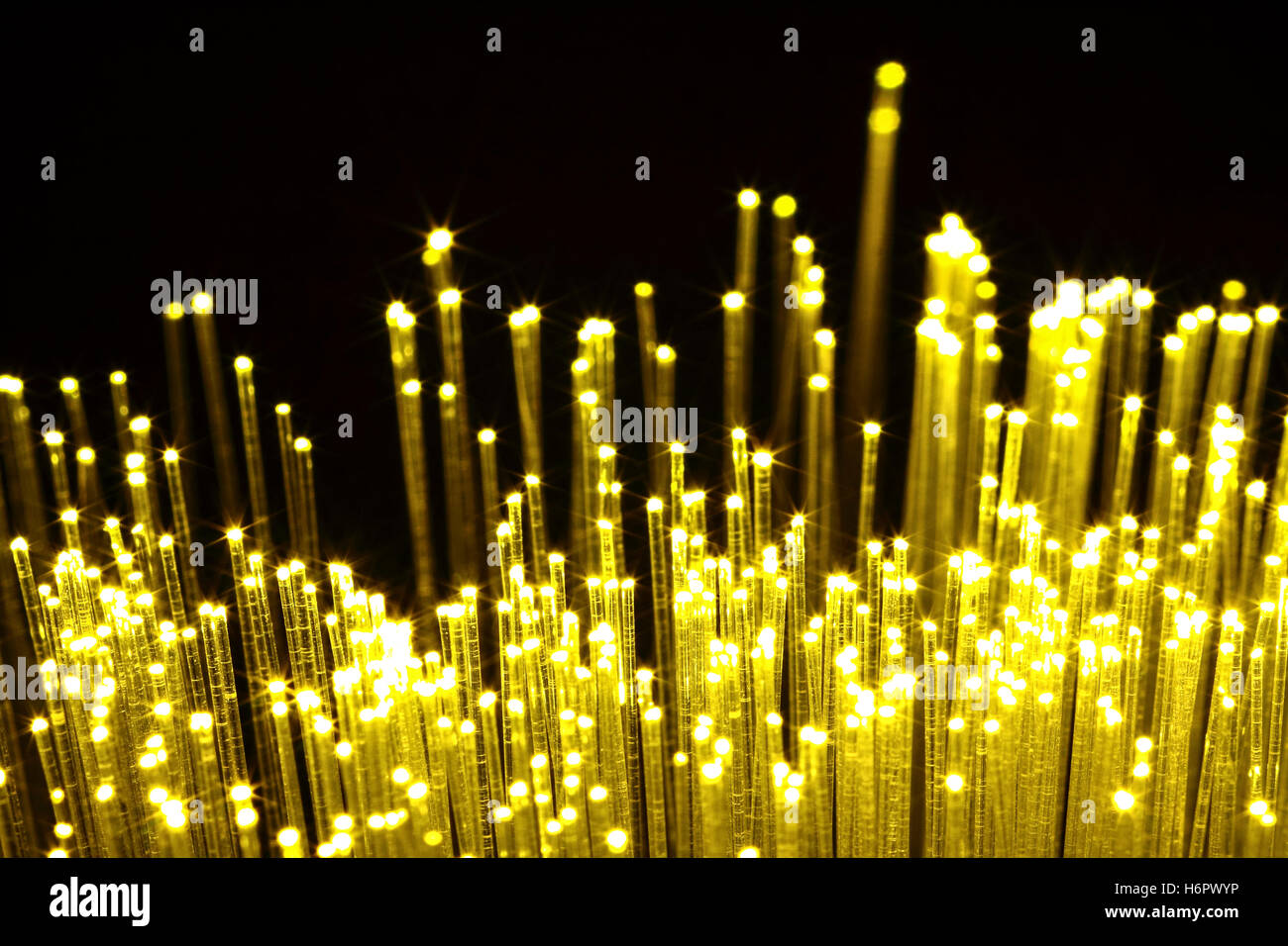close up view of amber (yellow) fibre optic strands conceptual use for information,digital transfer of data,internet,science and technology use Stock Photo