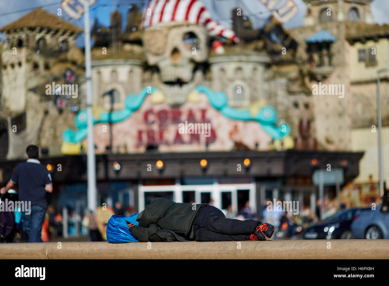 Blackpool sleeping tramp homeless   Holiday sea side town resort Lancashire tourist attractions person with belongings in bag sl Stock Photo