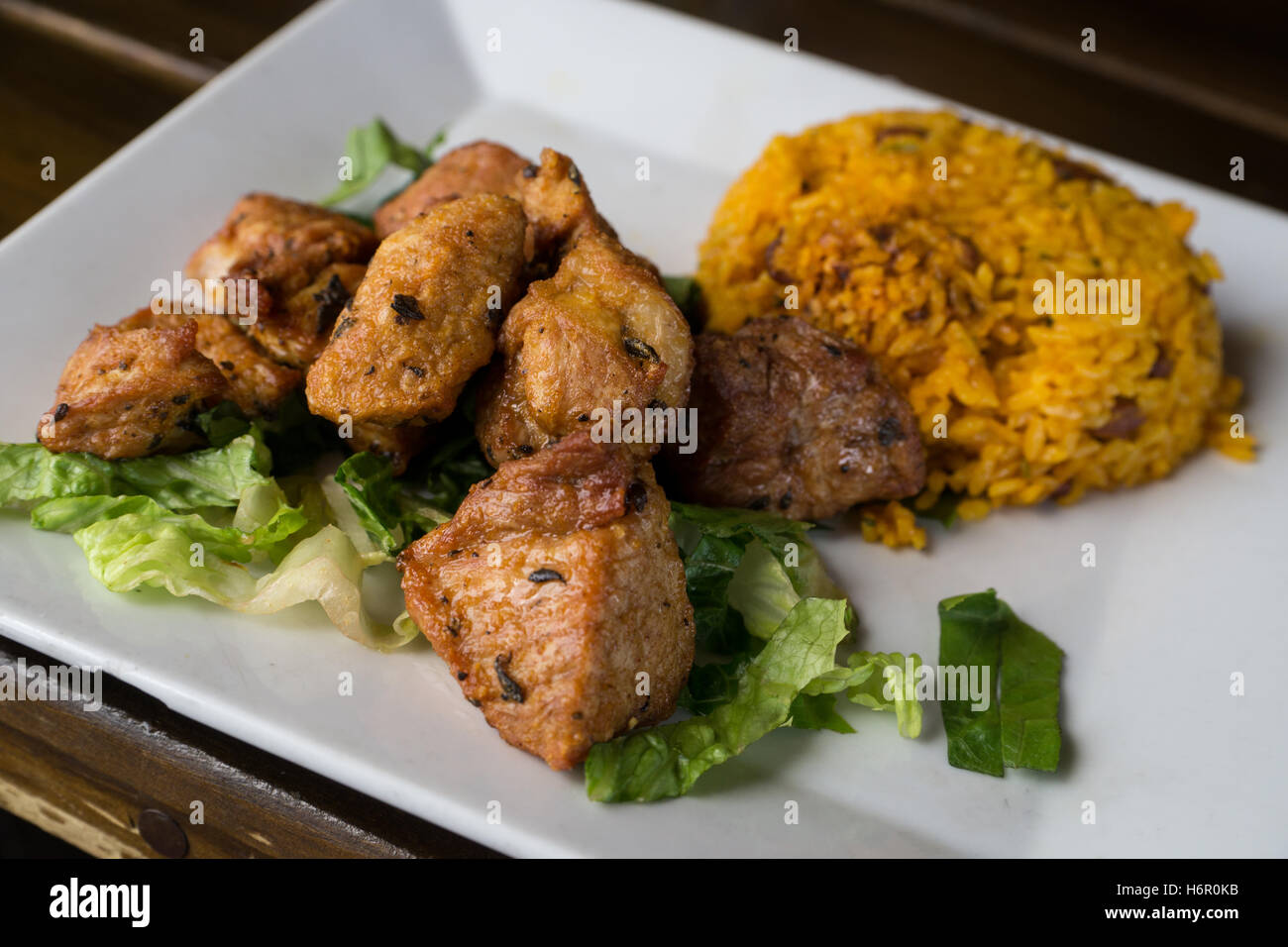 Carne frita (fried chunks of pork) with arroz mamposteado (blended Puerto Rican rice) at Punto de Vista rooftop restaurant, Old Stock Photo