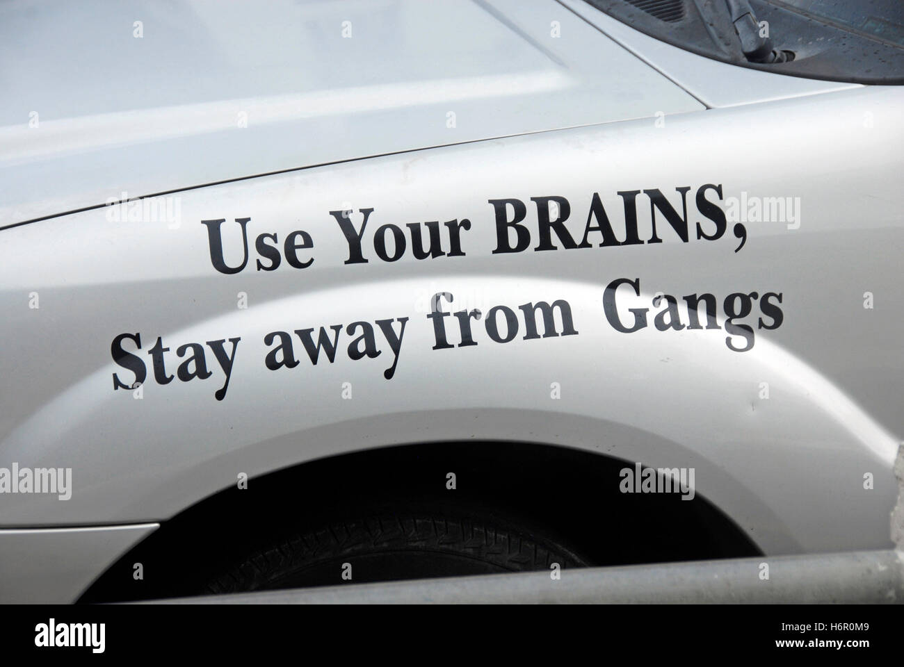 'Avoid Gangs' message on side of car Stock Photo