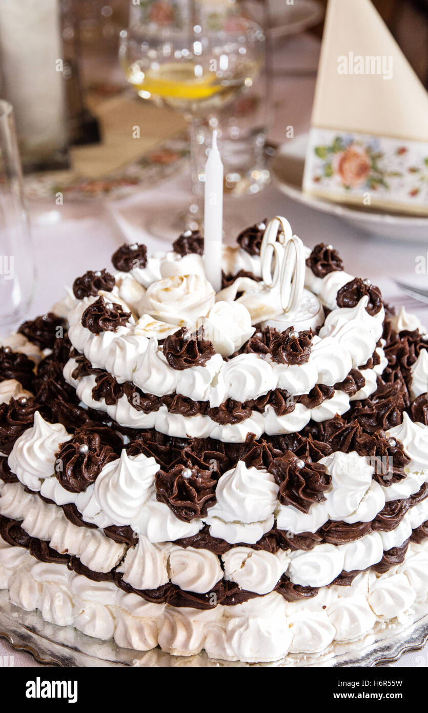 Big birthday chocolate and foam cake on the holiday table ...