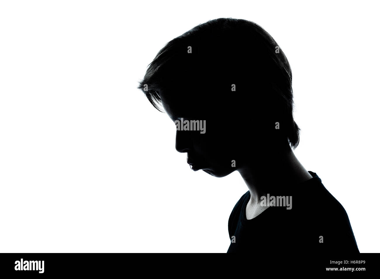 profile isolated face portrait blank european caucasian youth studio sadness one side view silhouette sulk sullen cut out kid Stock Photo
