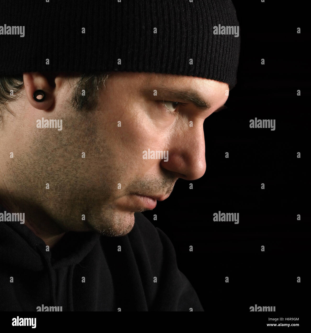 danger male masculine stare criminal theif thief danger closeup male masculine face portrait person eyes mood look glancing see Stock Photo