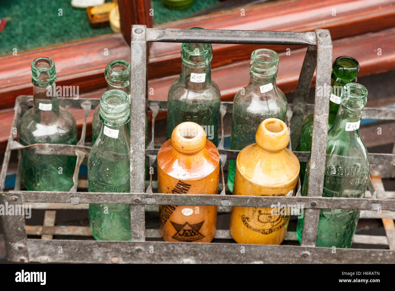 Crate of antique bottles outside an antique shop, Keswick, Cumbria, England Stock Photo